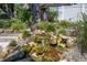 Landscaped yard featuring a beautiful stone waterfall feature at 37673 Dixie Ave, Dade City, FL 33525
