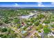 Aerial view featuring a suburban neighborhood with mature trees, showcasing the property's location and layout at 4105 W Bay Villa Ave, Tampa, FL 33611