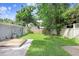 Spacious backyard with lush green grass, a wooden deck, and secure fencing, ideal for outdoor enjoyment at 4105 W Bay Villa Ave, Tampa, FL 33611