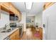 Bright kitchen featuring wood floors, stainless steel appliances, and a view of a dining area at 4105 W Bay Villa Ave, Tampa, FL 33611