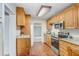 Functional kitchen featuring wooden cabinets, laminate countertops, and stainless steel appliances at 4105 W Bay Villa Ave, Tampa, FL 33611