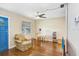 Cozy living room with a ceiling fan, wood floors, and a sitting area at 4105 W Bay Villa Ave, Tampa, FL 33611