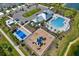 Overhead shot of the community clubhouse with pool, playground, tennis court, and ample parking at 414 Sunlit Coral St, Ruskin, FL 33570