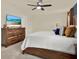 Comfortable bedroom with wooden furniture, including a dresser and a bed, and a cozy atmosphere at 414 Sunlit Coral St, Ruskin, FL 33570