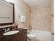 Cozy bathroom featuring granite countertop and tile surround tub, providing a soothing and functional space at 4230 Hartwood Ln, Tampa, FL 33618
