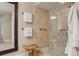 Bathroom with tiled walk-in shower, neutral tones, and convenient towel racks at 4230 Hartwood Ln, Tampa, FL 33618