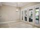 Open dining room with light floors and sliders to a furnished patio area at 4230 Hartwood Ln, Tampa, FL 33618