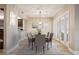 Traditional dining room with seating for six, modern lighting, and sliders to a patio at 4230 Hartwood Ln, Tampa, FL 33618