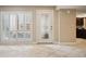 Bright foyer with decorative glass front door, neutral tile flooring, and large window with shutters at 4230 Hartwood Ln, Tampa, FL 33618