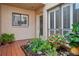 Charming home entrance featuring a decorative glass door and lush landscaping at 4230 Hartwood Ln, Tampa, FL 33618