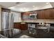 Eat-in kitchen featuring granite countertops, stainless steel appliances and window with shutters at 4230 Hartwood Ln, Tampa, FL 33618