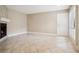 Open concept living room featuring tile floors, cozy fireplace, and exterior access at 4230 Hartwood Ln, Tampa, FL 33618