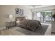 A serene bedroom offers modern décor, soft lighting, and a large window with outside view at 4230 Hartwood Ln, Tampa, FL 33618