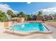Community pool surrounded by mature trees offering a refreshing escape and a social gathering space at 4230 Hartwood Ln, Tampa, FL 33618