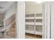 A view of the storage under the stairs with open shelves for easy access at 4230 Hartwood Ln, Tampa, FL 33618
