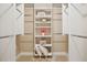 Organized walk-in closet with built-in shelving, hanging rods, and ample storage space at 4230 Hartwood Ln, Tampa, FL 33618