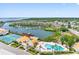 Stunning aerial view of the community featuring waterfront homes, a pool, a clubhouse, and tennis courts at 4306 Sunray Ct, Tampa, FL 33615