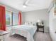 Bright bedroom with a ceiling fan, window views, and simple decor at 4306 Sunray Ct, Tampa, FL 33615