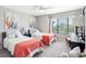 Bright bedroom with two twin beds, large window providing a view, and stylish decor for a comfortable space at 4306 Sunray Ct, Tampa, FL 33615