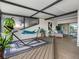 A relaxing covered patio features a comfortable hammock, plants, and lounge area for outdoor living at 4306 Sunray Ct, Tampa, FL 33615