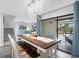 Dining area featuring a wood table with bench seating, chandelier and glass sliding doors to a patio at 4306 Sunray Ct, Tampa, FL 33615
