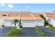 Charming townhomes featuring two-car garages, neutral paint and desert landscaping offer curb appeal at 4306 Sunray Ct, Tampa, FL 33615