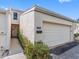 This townhouse features a two-car garage, neutral stucco exterior, and well-kept landscaping at 4306 Sunray Ct, Tampa, FL 33615