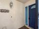 A blue front door with glass accents enhances curb appeal, complemented by address numbers and stucco wall at 4306 Sunray Ct, Tampa, FL 33615