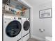 Convenient laundry area with modern washer and dryer, plus shelving for storage at 4306 Sunray Ct, Tampa, FL 33615