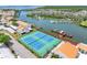 Aerial view of community tennis courts with a waterfront view and boat docks at 4306 Sunray Ct, Tampa, FL 33615