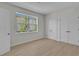 Bright bedroom with view to backyard and light wood floors at 455 Pinellas Bayway S # 2B, Tierra Verde, FL 33715
