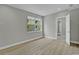 Bedroom featuring view to the side yard and light-colored wood floors at 455 Pinellas Bayway S # 2B, Tierra Verde, FL 33715