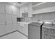 Spacious laundry room featuring modern appliances, ample cabinet space, and stylish backsplash at 455 Pinellas Bayway S # 2B, Tierra Verde, FL 33715