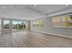 Bright living room with wood flooring and many windows with a view of the canal at 455 Pinellas Bayway S # 2B, Tierra Verde, FL 33715