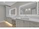 Elegant bathroom featuring dual sinks, vanity space, backlit mirrors and ample storage in a modern design at 455 Pinellas Bayway S # 4A, Tierra Verde, FL 33715