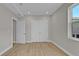 Neutral bedroom featuring wood-look flooring, natural light, and a spacious closet with double doors at 455 Pinellas Bayway S # 4A, Tierra Verde, FL 33715