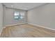 Bright, modern bedroom featuring recessed lighting, wood flooring, and a view to the outdoors through a picture window at 455 Pinellas Bayway S # 4A, Tierra Verde, FL 33715