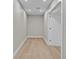 Hallway with light wood floors, white trim, and neutral walls creating a bright and inviting space at 455 Pinellas Bayway S # 4A, Tierra Verde, FL 33715