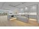 Open-concept kitchen with gray cabinets, stainless steel appliances, and an island with pendant lighting at 455 Pinellas Bayway S # 4A, Tierra Verde, FL 33715