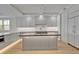 Contemporary kitchen featuring a large island, white cabinetry, and ample counter space at 455 Pinellas Bayway S # 4A, Tierra Verde, FL 33715