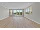 Bright living room with wood floors and expansive windows offering serene water views at 455 Pinellas Bayway S # 4A, Tierra Verde, FL 33715