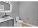 Stylish powder room with a unique vessel sink, modern faucet, and a sleek, lighted mirror at 455 Pinellas Bayway S # 4A, Tierra Verde, FL 33715