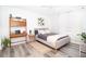 Serene bedroom with a plush bed, wood-look flooring, and contemporary decor for a relaxing retreat at 5129 Se Salmon Se Dr # A, St Petersburg, FL 33705
