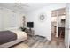 Comfortable bedroom with white walls, wood-look flooring, and a glimpse into the well-lit kitchen at 5129 Se Salmon Se Dr # A, St Petersburg, FL 33705