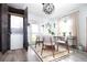 Dining area with a modern table and chairs, complemented by a washer/dryer in the cabinets at 5129 Se Salmon Se Dr # A, St Petersburg, FL 33705