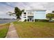 Two-story waterfront home features a private balcony, patio area, and scenic lawn at 5129 Se Salmon Se Dr # A, St Petersburg, FL 33705