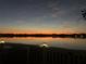 Beautiful view of water reflecting sunset colors from covered porch with railing at 5129 Se Salmon Se Dr # A, St Petersburg, FL 33705