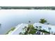 Condos on the water featuring lush landscaping, mature trees, and parking at 5129 Se Salmon Se Dr # A, St Petersburg, FL 33705