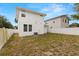 Expansive backyard featuring a well-maintained lawn, modern fencing, and an AC unit at 5501 N 15Th St, Tampa, FL 33610