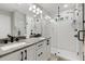 Modern bathroom with double vanity, granite counters, and a glass-enclosed shower at 5501 N 15Th St, Tampa, FL 33610